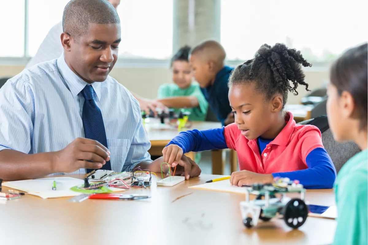 A teacher and learners with a robot in class