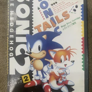 Used Sonic The Hedgehog 2 Sega Mega Drive cartridge with Sonic and Tails label inside open black case, minor label wear.